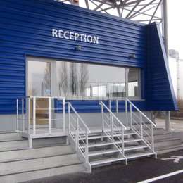 Aluminium stairs and platform for accessing a public building reception desk.