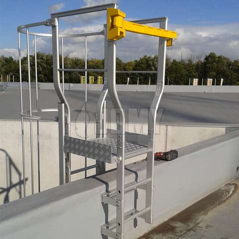 Custom made cage ladder roof landing for parapet crossing.