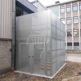 Enclosed staircase in aluminium with perforated panels and security door.