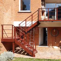 Exterior metal stairs for a mezzanine balcony Custom metal stairs and guardrails for a mezzanine balcony