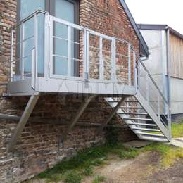 Exterior metal stairs with custom landing platform Custom landing platform with guardrails that can be opened