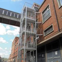 Fire escape industrial staircase outside of a factory building.