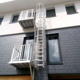 2 story counterbalanced fire escape cage ladder with access balconies on a building.