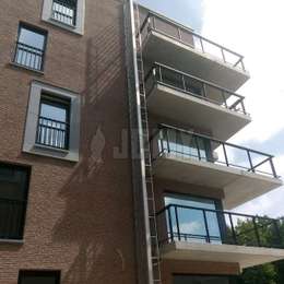 4 story fire escape retractable ladder in the open position for a residential building.