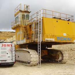 Heavy-duty excavator with a drop-down ladder for accessing the cabin.