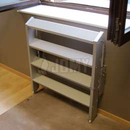 Aluminium step ladder that can be folded along the wall for saving space. Used under a window for egress.