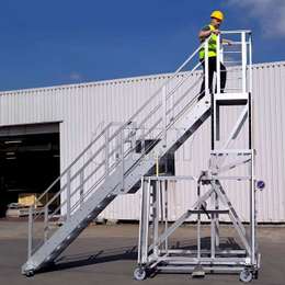 Telescopic work platform on wheels with height adjustability.