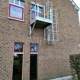 Ladder with cage and access balcony for fire evacuation.