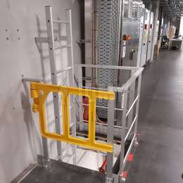 Manhole ladder with guardrails and security gate.