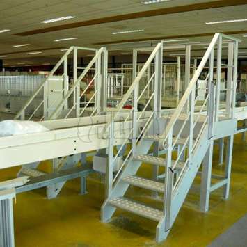 Overstapbordes met parallelle trappen op een fabrieksleidingen.
