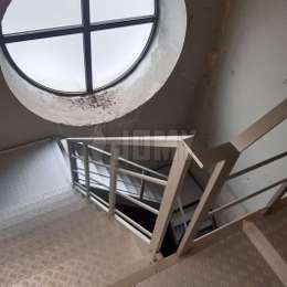 Quarter-turn access stairs located at the base of the bell tower and fixed to the walls by brackets.