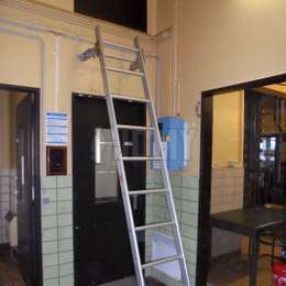 Hook ladder used to access a service door situated above a corridor door.