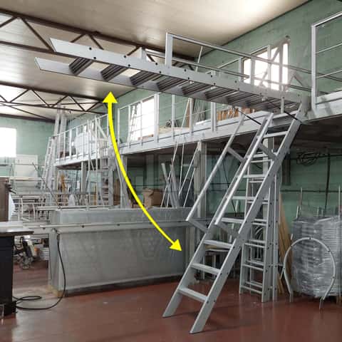 Aluminium ship ladder mounted on gas springs and used to access an industrial mezzanine.