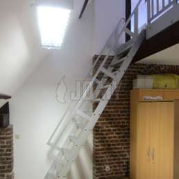 Ship ladder with guardrails used to access a classroom mezzanine.