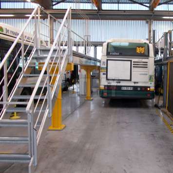 Industrial aluminium stairs and platform for bus maintenance in a repair shop / garage.