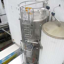 Cage ladder with rest platforms used on storage tanks for maintenance.