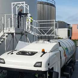 Aluminium truck loading platform with fall-protection used to access tanker truck hatches.